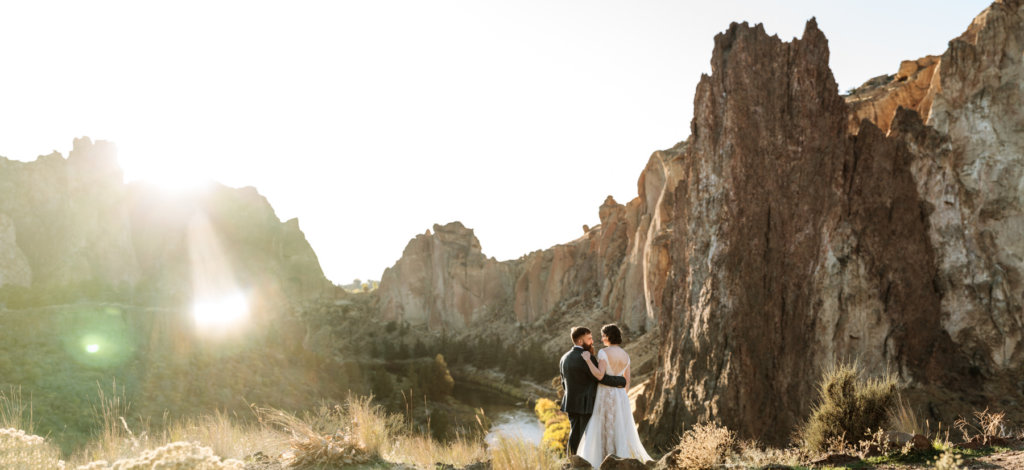 Panoramic image of couple at Smith Rock state park. 