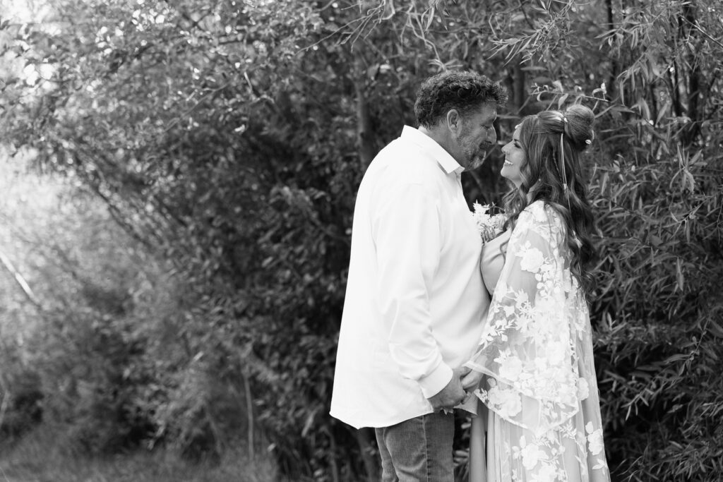Black and white photo of couple about to kiss at Shevlin Park.