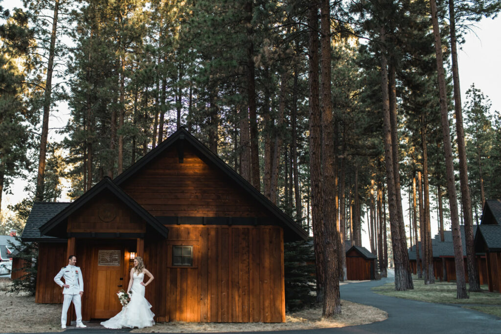 Couple outside cabin in Five Pines Lodge. 