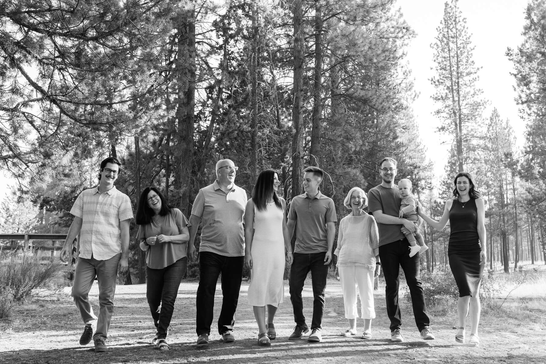 Black and white image of the entire family walking down a path at Shevlin Park. 