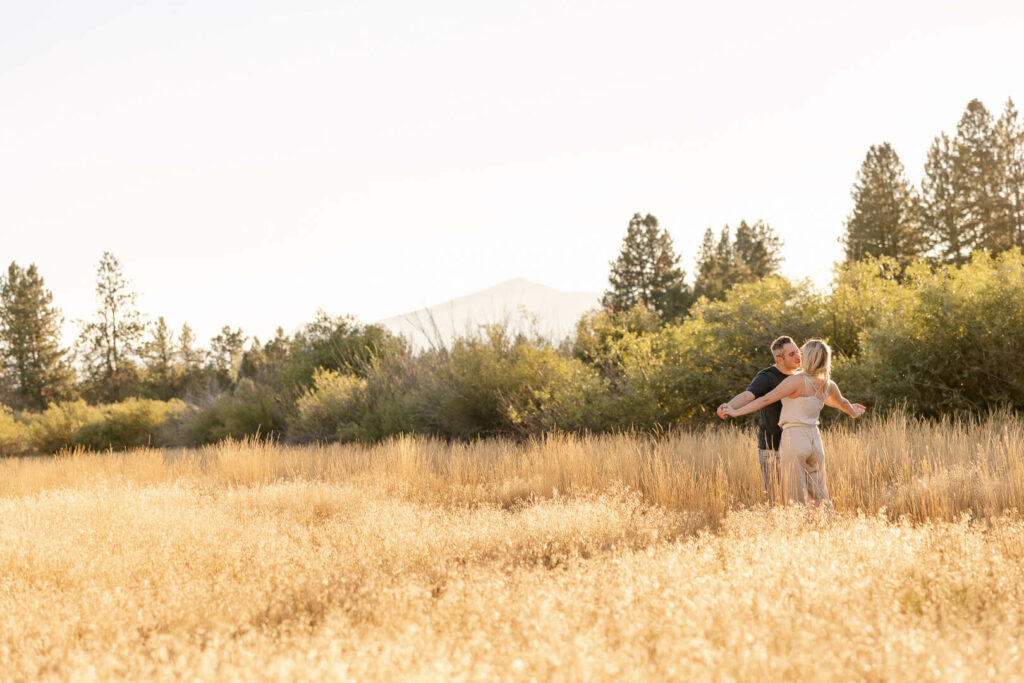 Couple in a field after proposal.