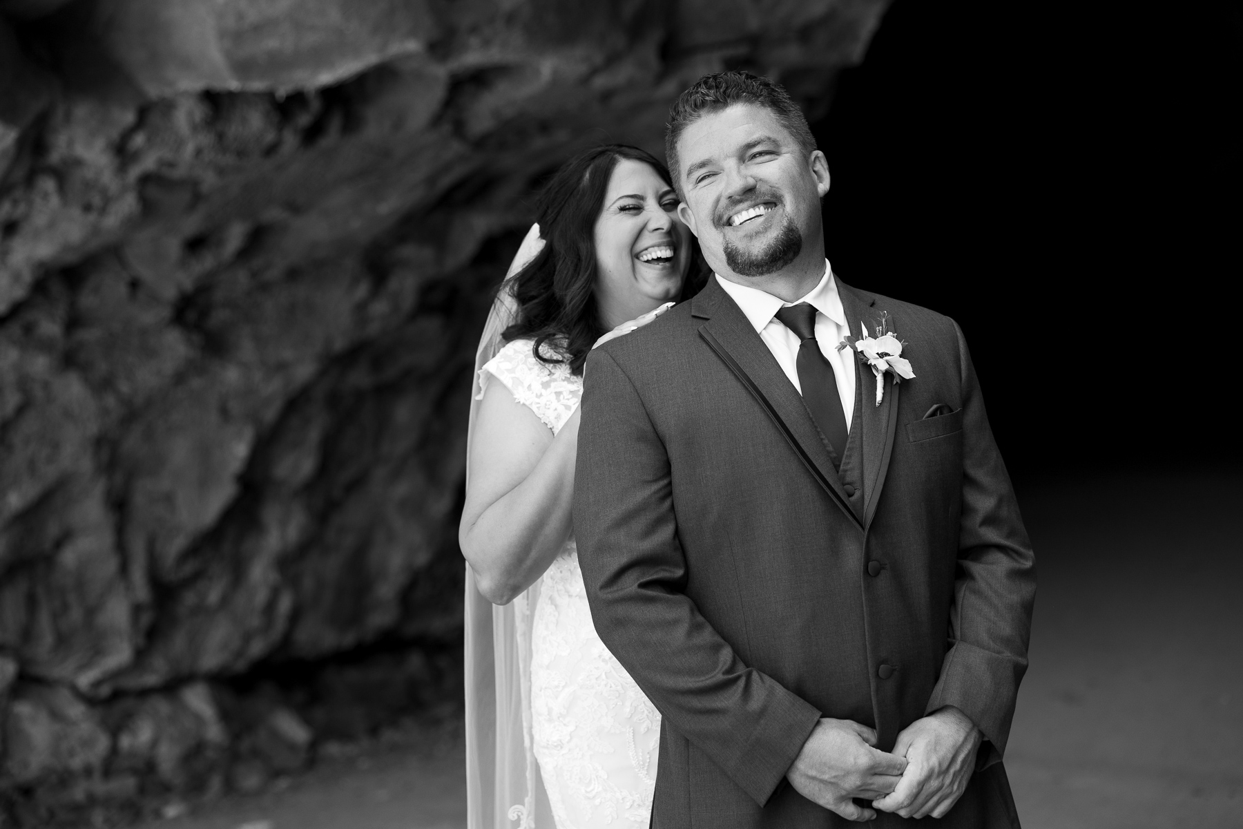 Black and white image of couple having a moment inside the cave at Juniper Preserve.