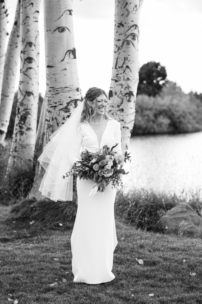 Black and white portrait of stunning bride laughing. 