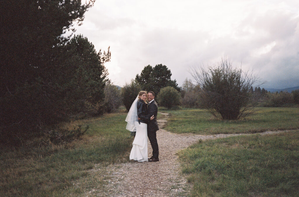 35mm grainy film shot of the wedding couple in the meadow at Black Butte Ranch. 