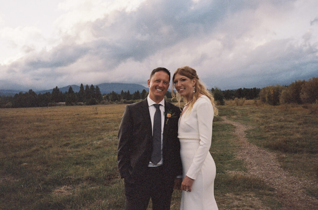 35mm grainy film shot of the wedding couple in the meadow at Black Butte Ranch. 