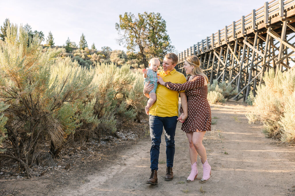 Young family walking down dirt trail in the high desert.