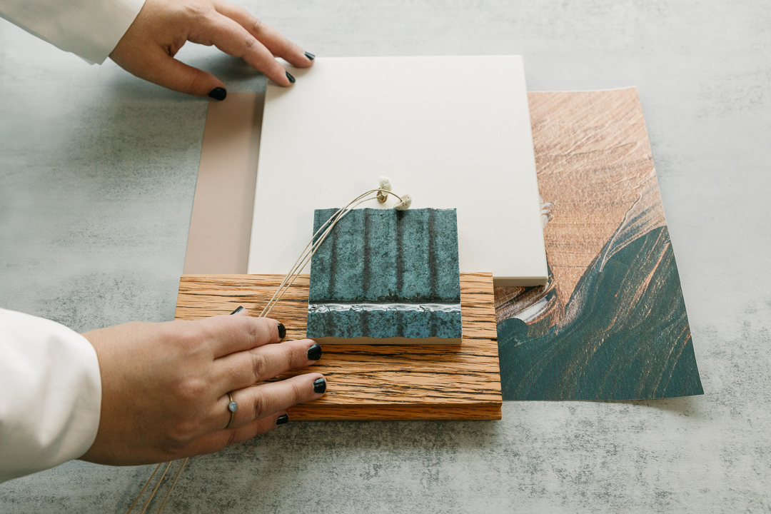 Close up of hands with design tiles and elements.