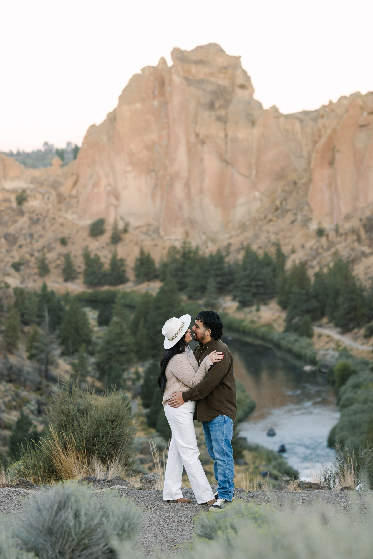 Couple share a kiss at Smith Rock Park in Oregon.